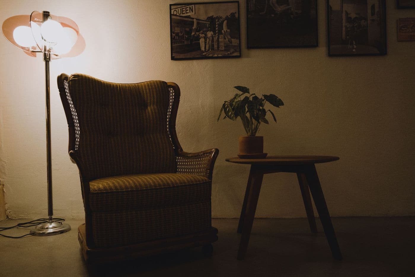 Vintage armchair in a serene setting with gentle lighting and a side table adorned with a plant.